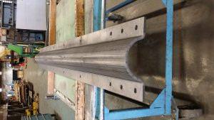 20 foot long part that looks rolled but in fact was step formed on a brake press at VeriForm. This is a communication tower stiffening clamp to help in high ice conditions to reinforce older towers. Part was made from 3/8 inch structural plate.