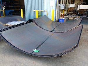 The following photo is showing large 0.25 inch thick steel panels rolled with windows for access holes.