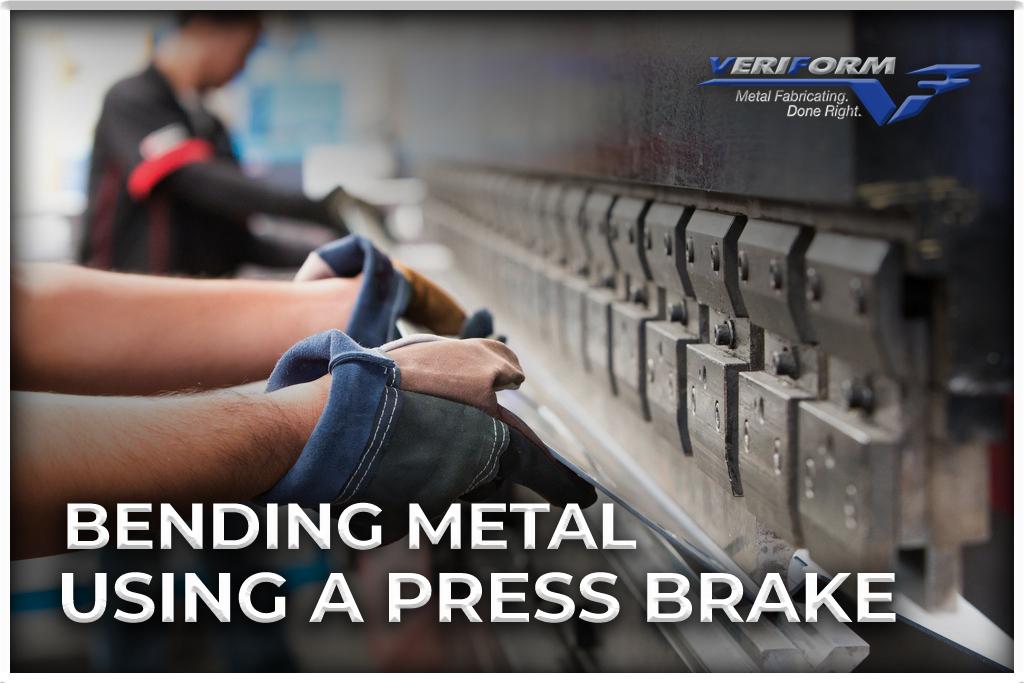 employee using a press brake to bend a metal sheet.